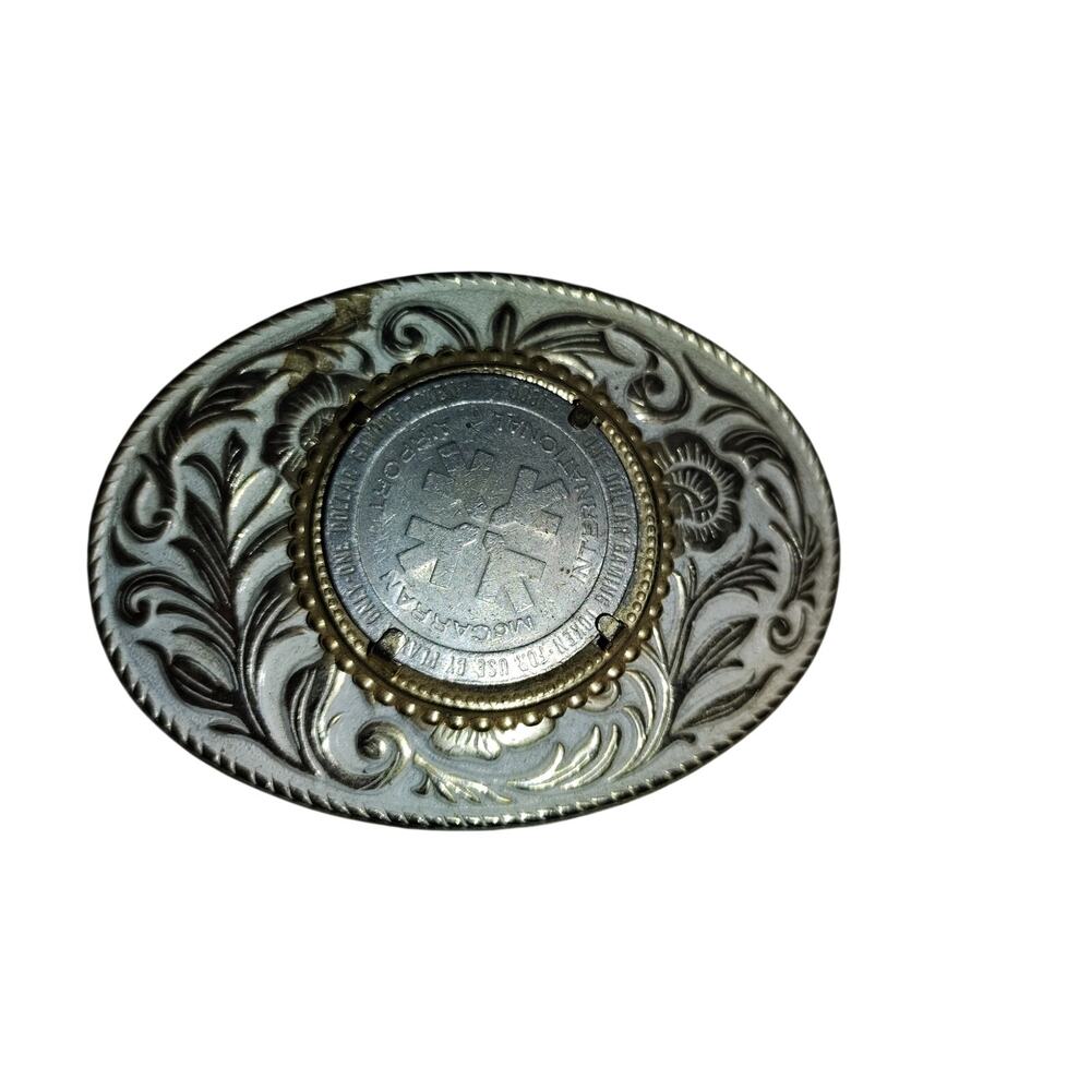 vintage brass metal belt buckle that functions as a coin or casino chip holder.
